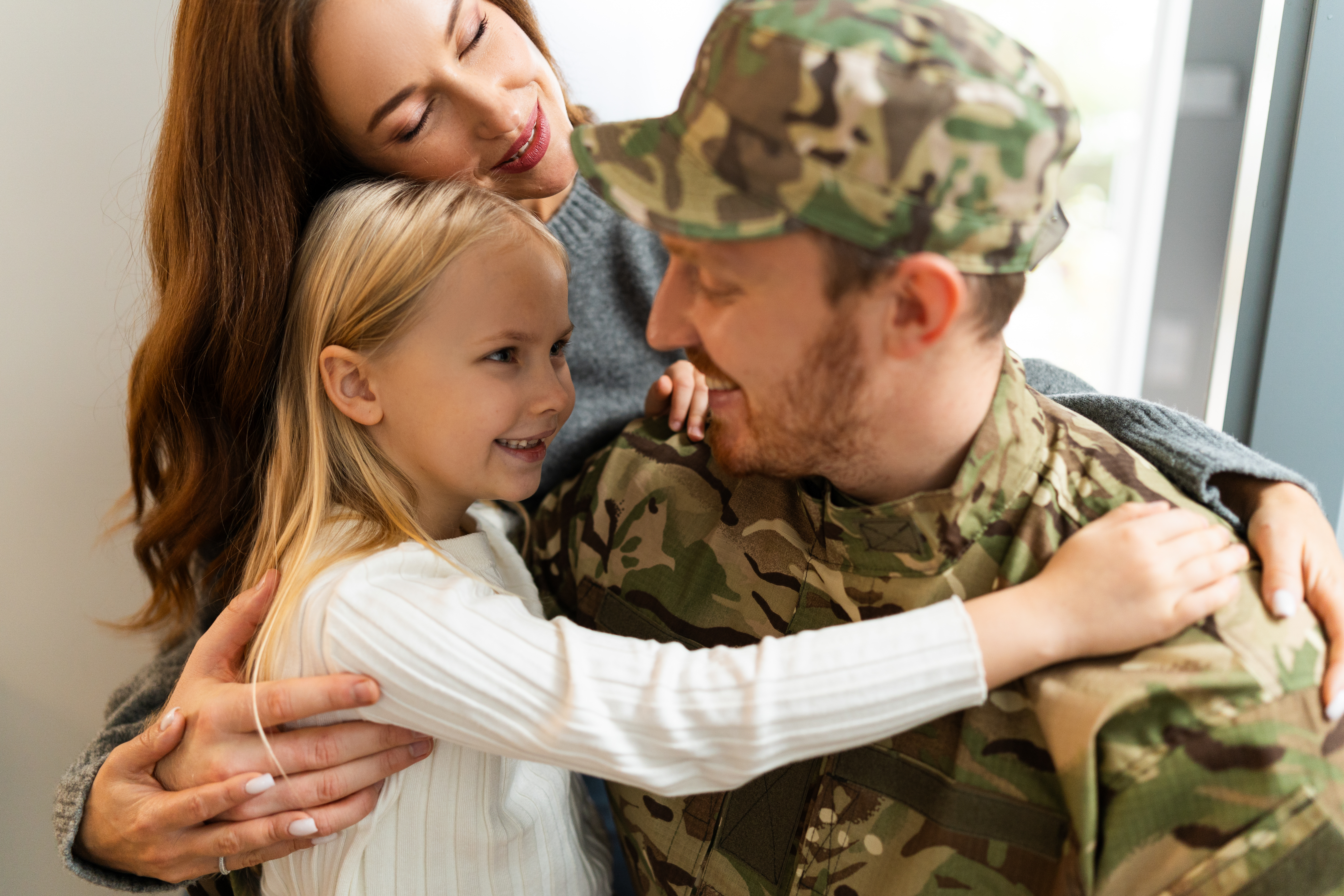 Rejoicing military man hugging family when coming back home